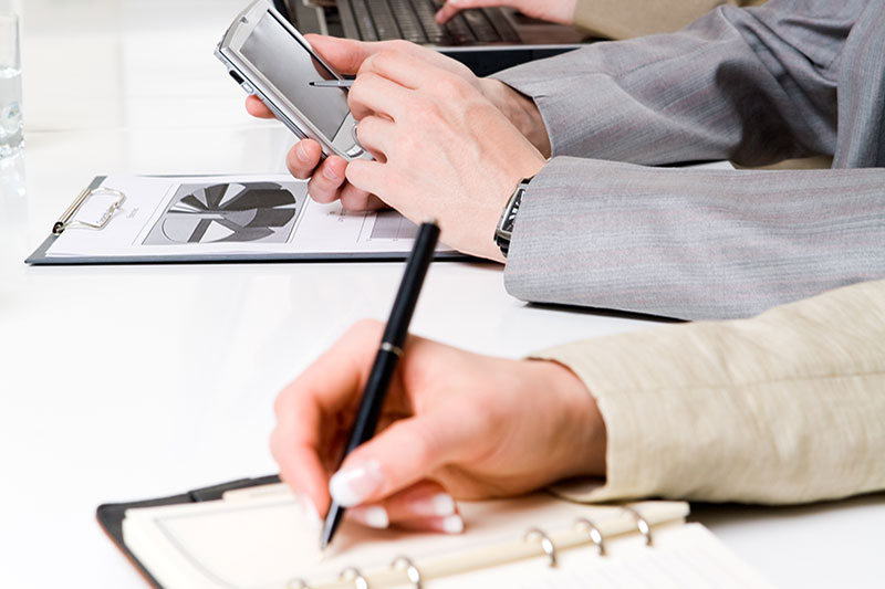 Hands taking notes for education.